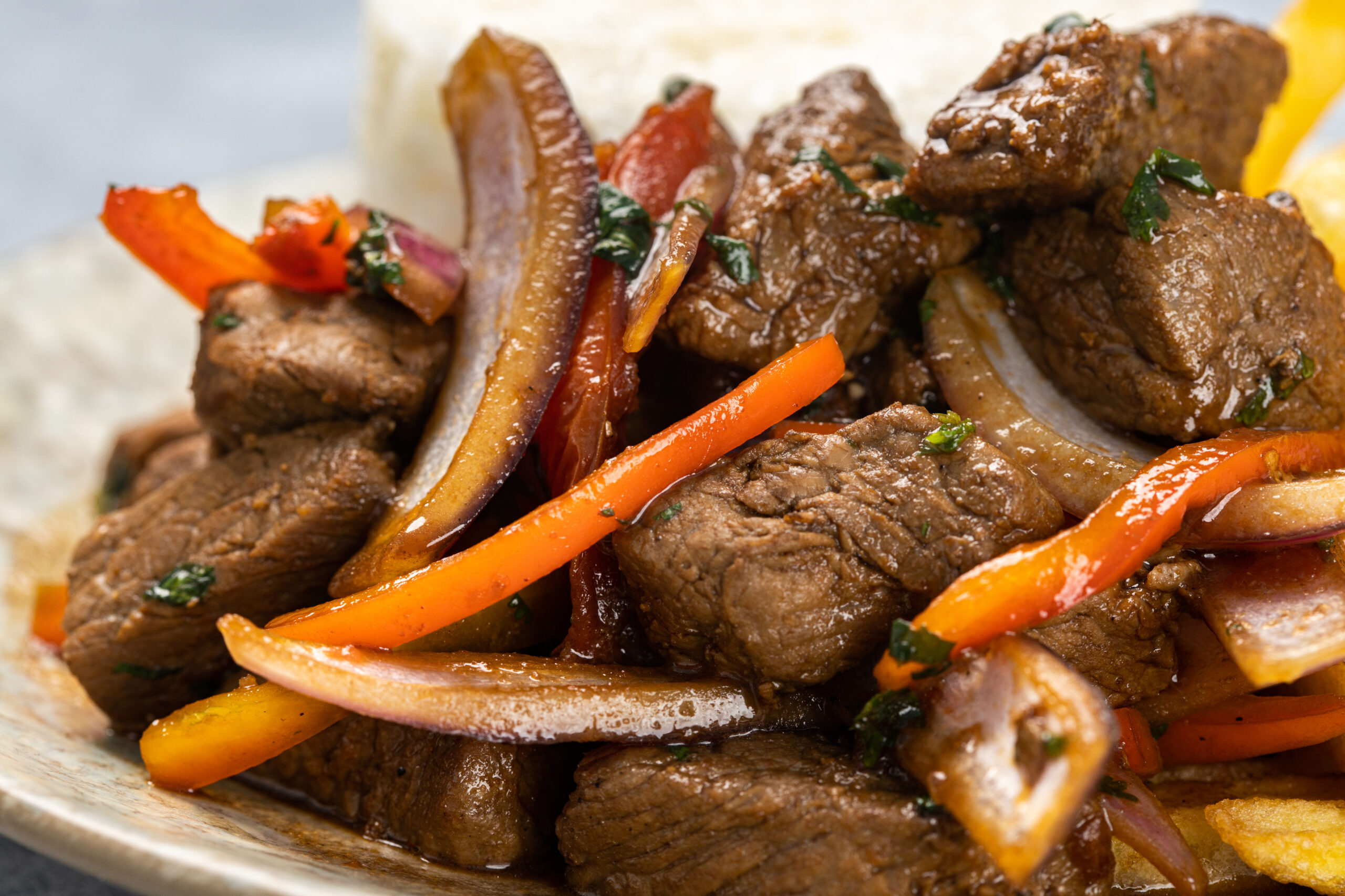 A closeup of delicious roasted meat with vegetables under the lights